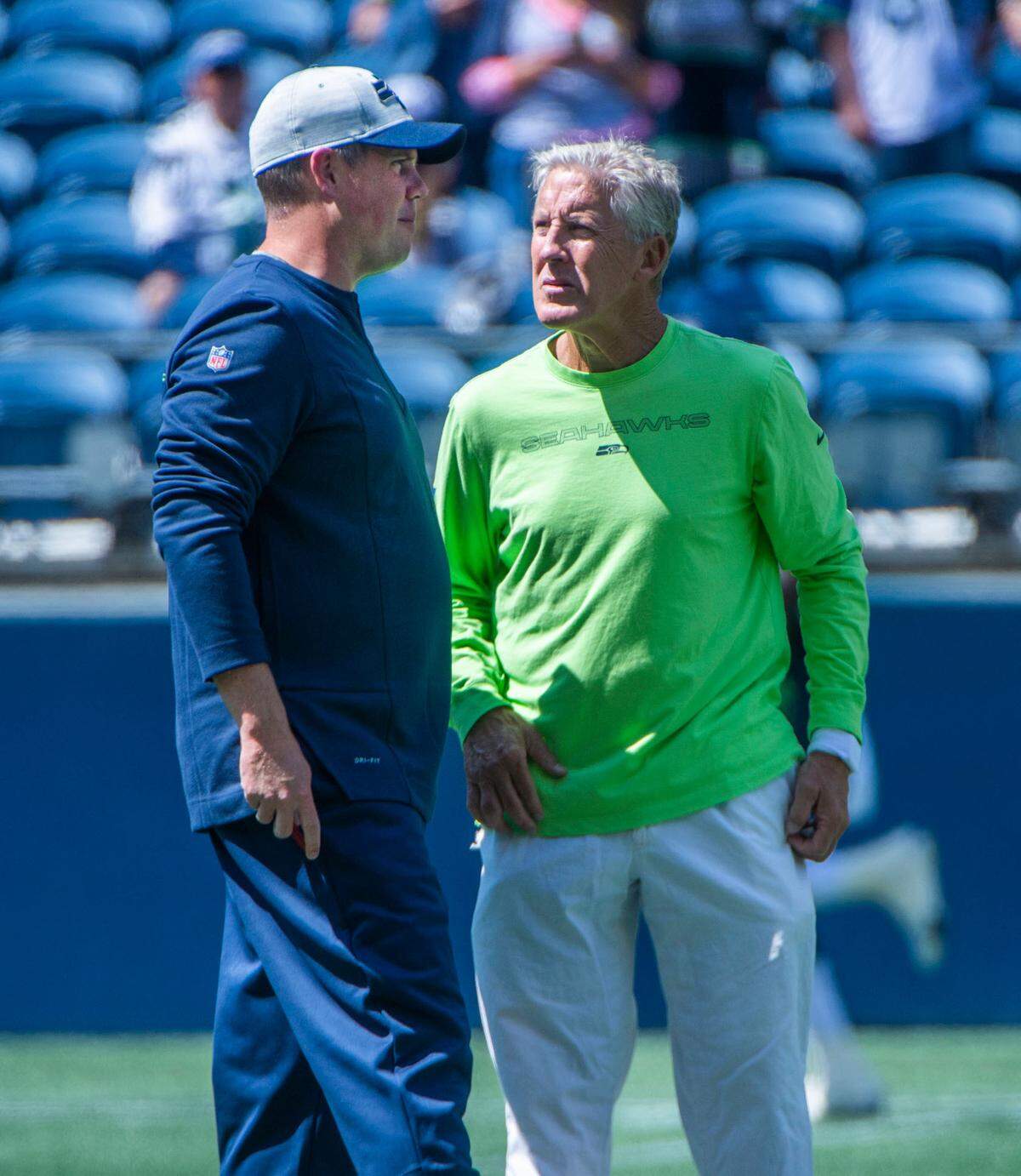 Seahawks coach Pete Carroll confers with offensive coordinator Shane Waldron prior to the annual training camp mock game at Lumen Field in Seattle on August, 5, 2021.
