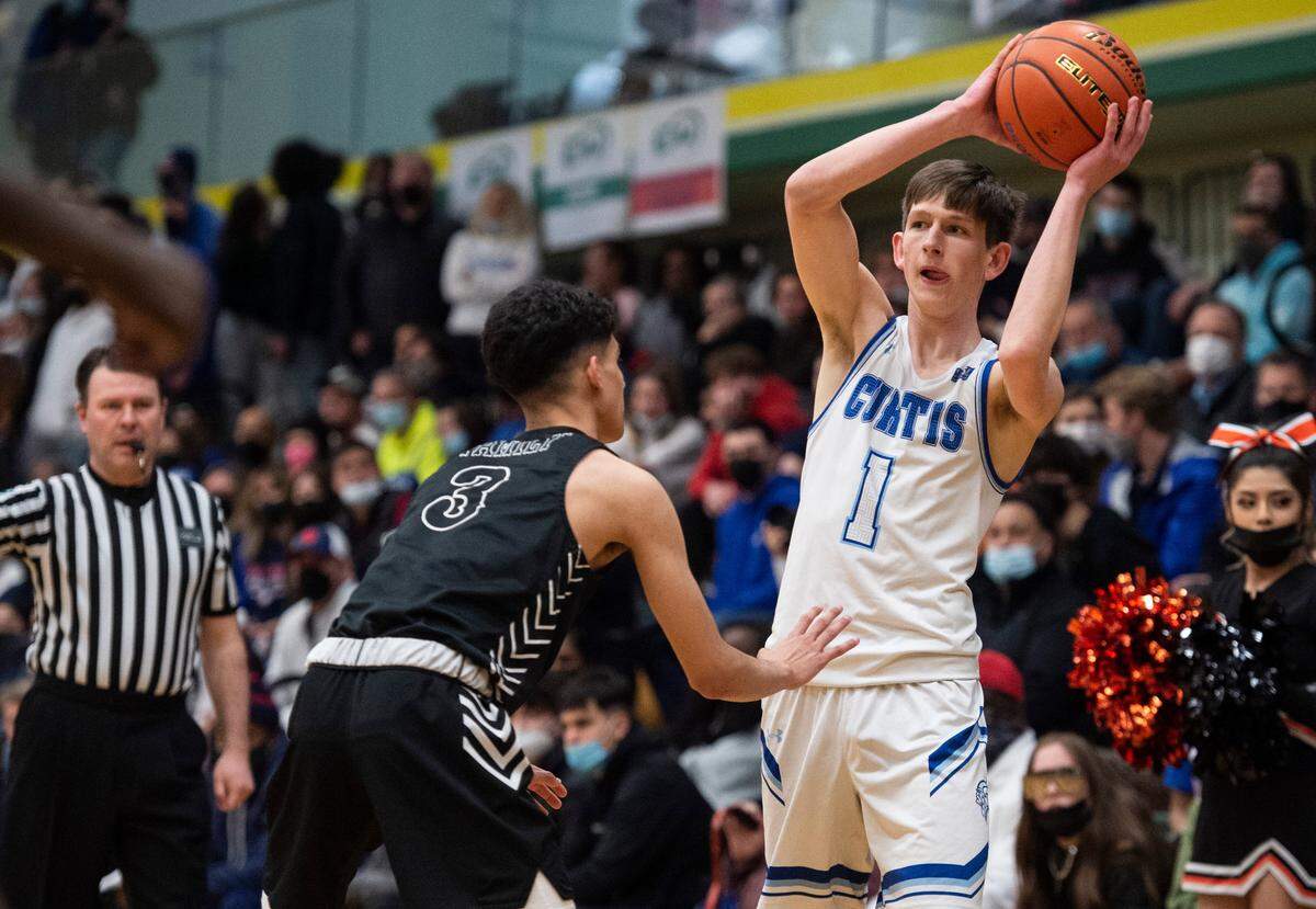 Curtis’s guard Tyce Paulsen (1) looks to pass the ball as Davis’s guard Cesar Hernandez (3) defends during the high school boys 4A basketball state tournament regional round game at Foss High School in Tacoma, Wash. on Saturday, Feb. 26, 2022.