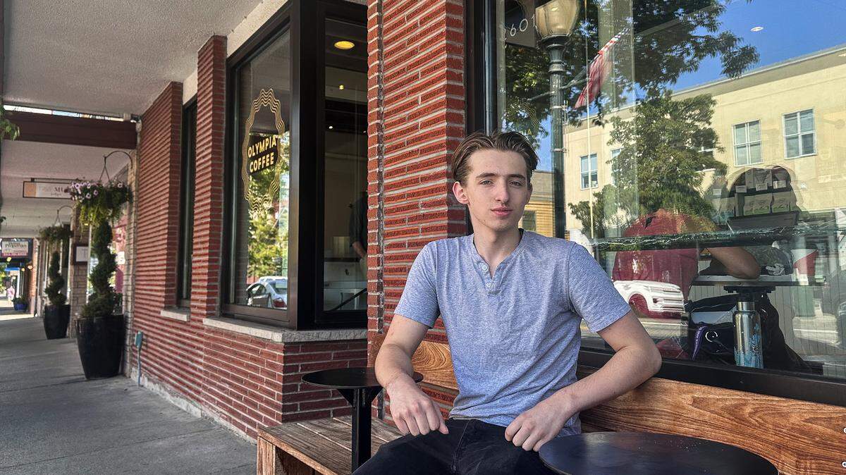 Samuel L. Pierce, 17, sits outside of Olympia Coffee in Tacoma on July 6. Olympia Coffee was one of the locations used to film his second feature film, “The Get Rich Quick Scheme”.