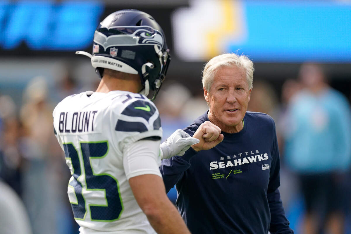 Seattle Seahawks safety Joey Blount (35) greets head coach Pete Carroll before an NFL football game against the Los Angeles Chargers Sunday, Oct. 23, 2022, in Inglewood, Calif. (AP Photo/Mark J. Terrill)