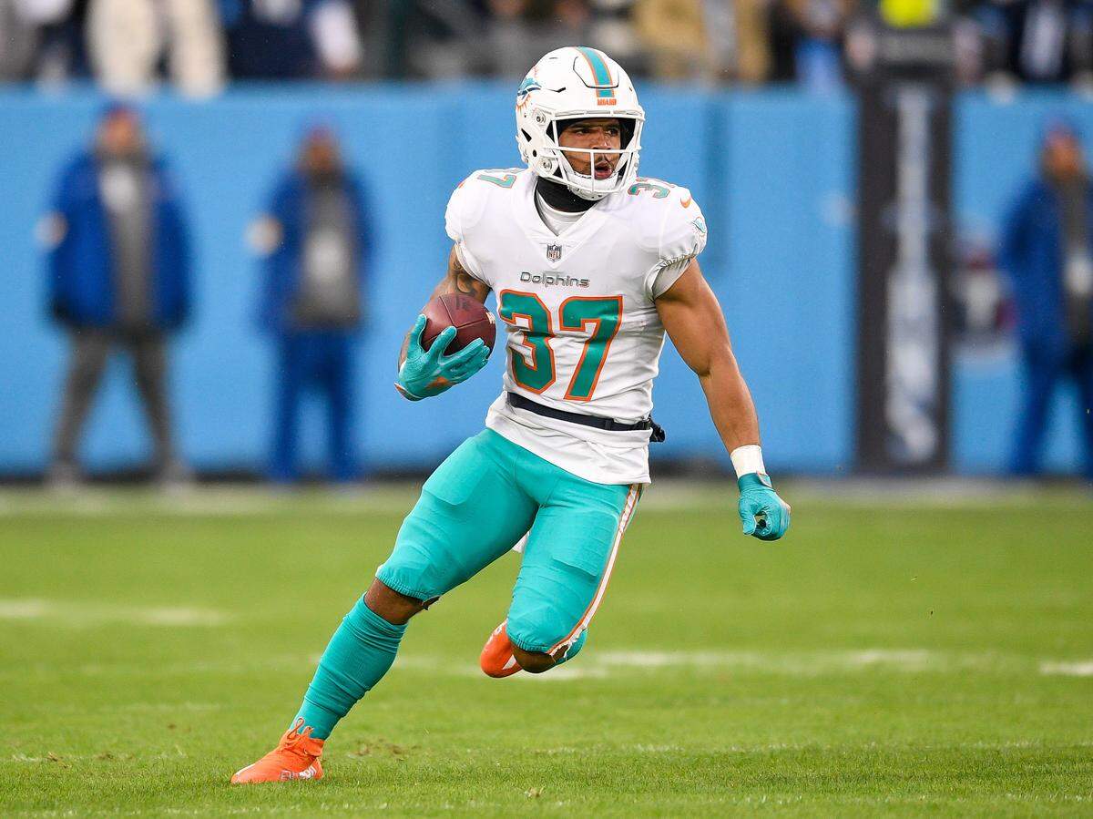 Jan 2, 2022; Nashville, Tennessee, USA; Miami Dolphins running back Myles Gaskin (37) runs the ball against the Tennessee Titans during the first half at Nissan Stadium. Mandatory Credit: Steve Roberts-USA TODAY Sports