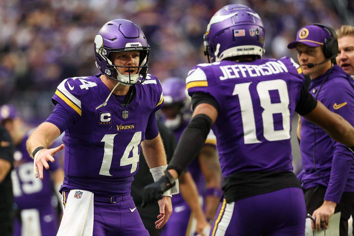 Dec 8, 2024; Minneapolis, Minnesota, USA; Minnesota Vikings quarterback Sam Darnold (14) celebrates his touchdown pass to wide receiver Justin Jefferson (18) against the Atlanta Falcons during the second quarter at U.S. Bank Stadium. Mandatory Credit: Matt Krohn-Imagn Images