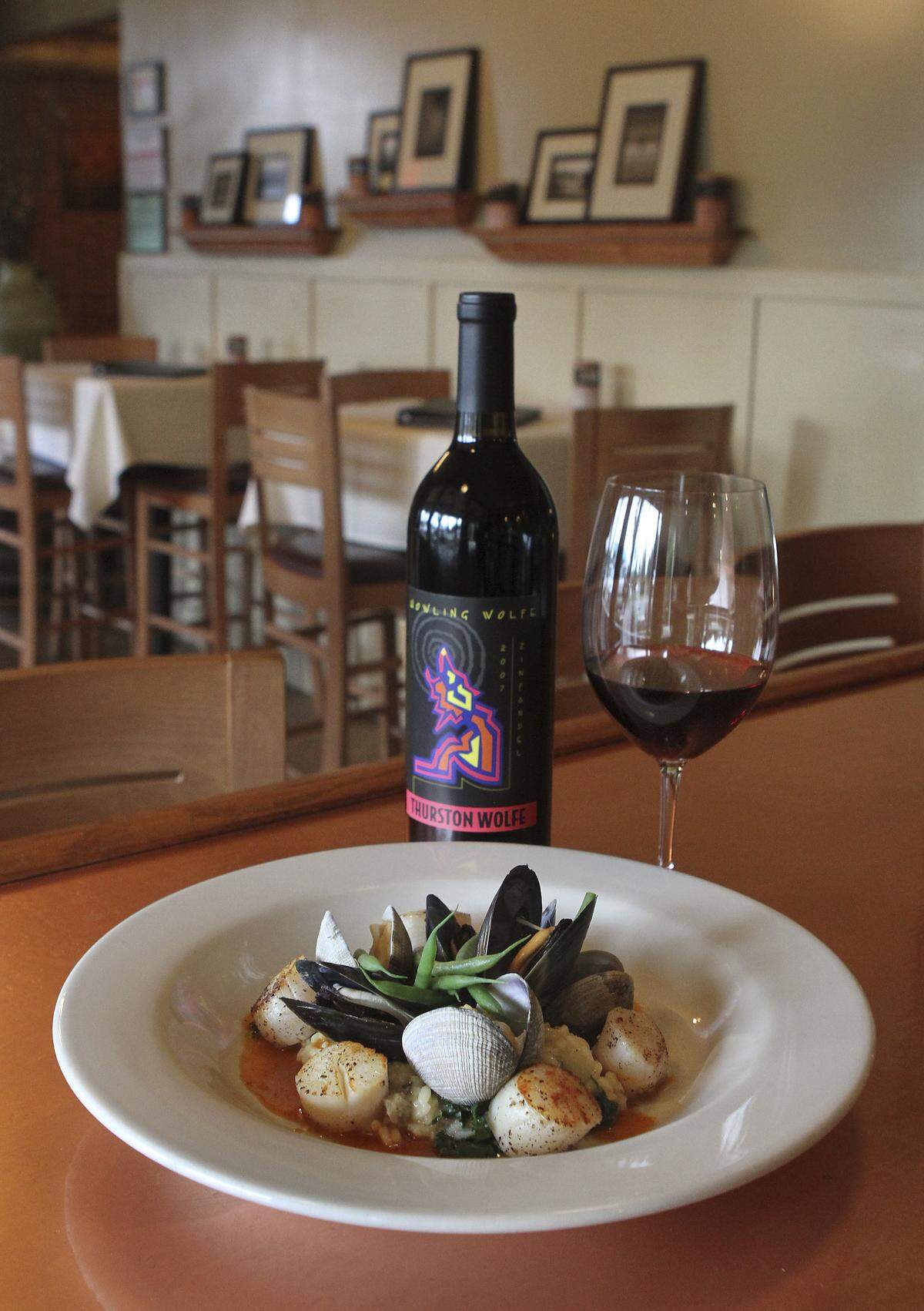 Chef Thad Lyman of Brix 25 pairs a Howling Wolfe Zinfandel with his pan-seared wild Japanese scallops, local clams and mussels in Gig Harbor on Friday, March 12, 2010.