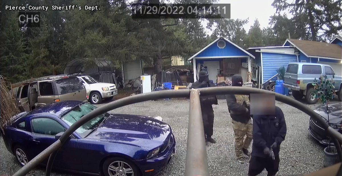 Surveillance video from a Jan. 4, 2023, home-invasion robbery in Elk Plain allegedly shows Timothy Rozier (right) and two masked men about to enter a residence where a 71-year-old woman was zip-tied and robbed at gunpoint. The men falsely claimed to be U.S. Marshals.