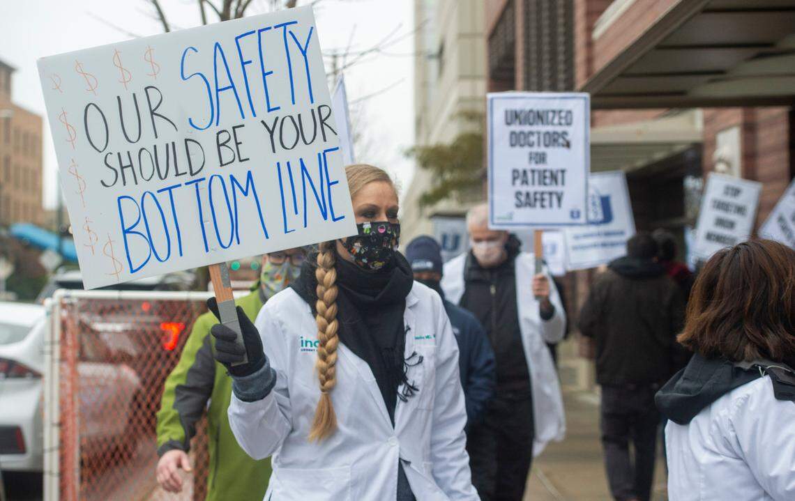 Doctors, nurse practitioners, physician assistants, and other members of the labor community picket at MultiCare Tacoma General to support striking Indigo Urgent Care providers Monday, Nov. 23, 2020. Indigo providers say MultiCare is forcing them to work excessively long and fatiguing shifts and failing to provide N95 masks as they test hundreds of COVID-19 patients each day.