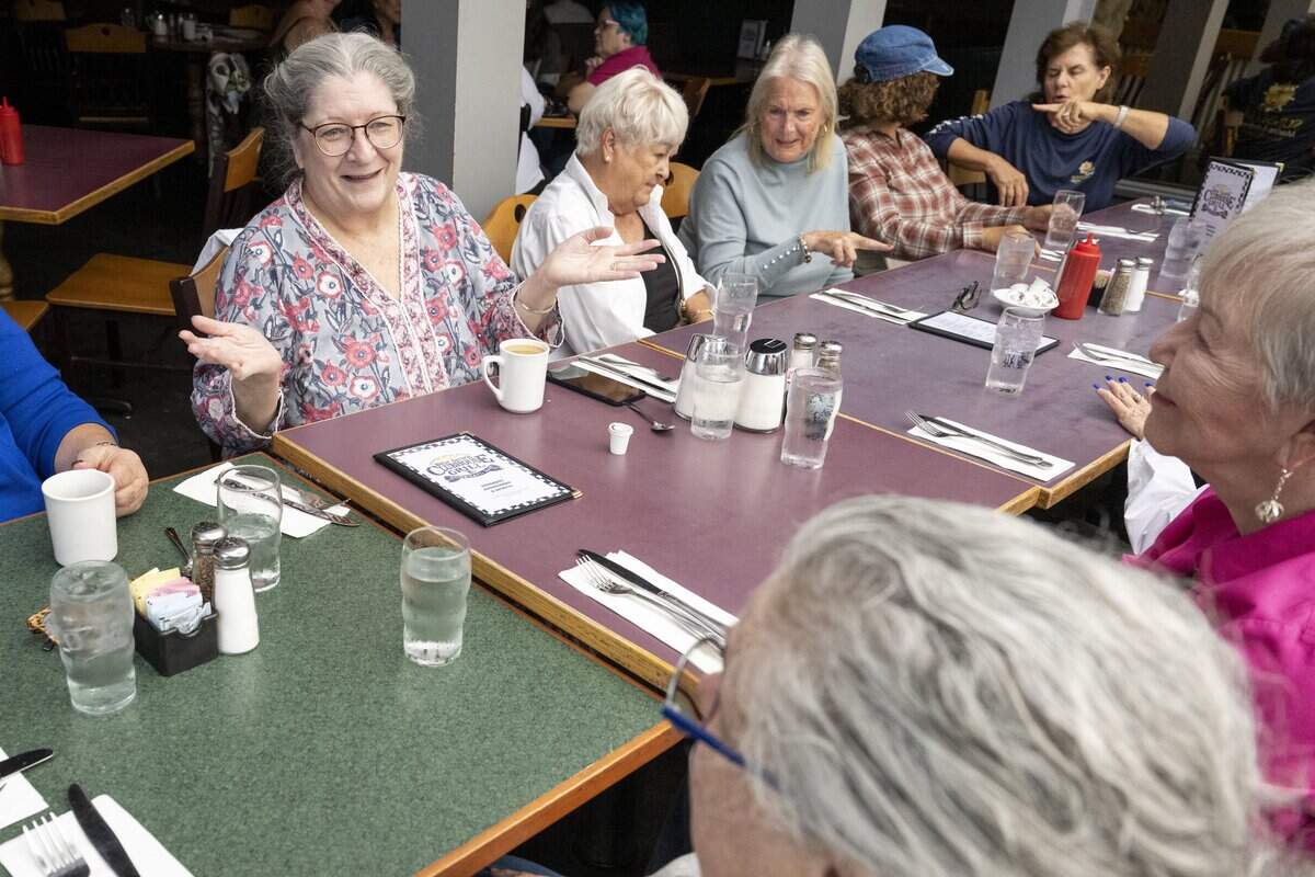 Tamara Sharp, left, talks with friends at a Nice Old Ladies friendship group meet up on Friday, Sept. 12, 2025, at Ben Dews Bar and Grill in Tacoma. Sharp originally organized the group through a Nextdoor post inviting other elderly women looking for community to gather and meet up for coffee or lunch.