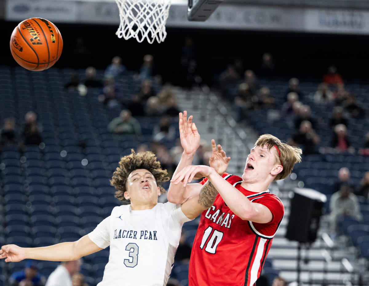 Glacier Peak’s Isaiah Cuellar-Bell (3) collides with Camas’ Matthew Sitler (10) as he kicks out a rebound during the first round of the Class 4A state tournament game at the Tacoma Dome, on Wednesday, Feb. 28, 2024, in Tacoma, Wash.
