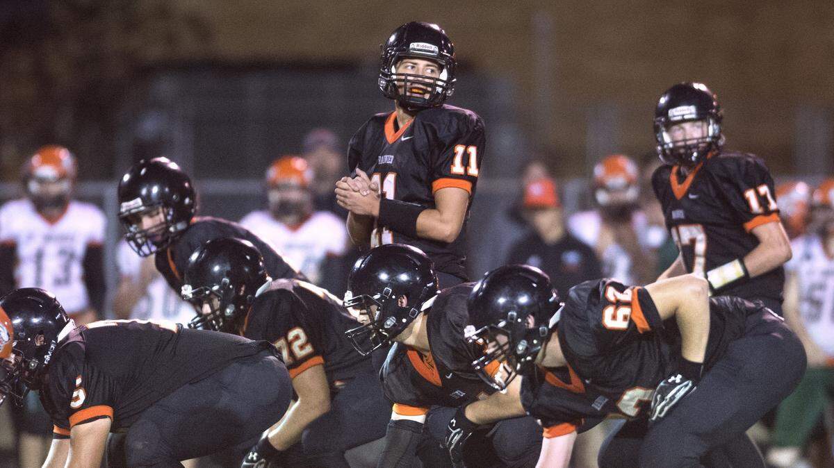 Rainier junior quarterback Zachary Lofgren (11) and the Mountaineer offense during Friday night’s football game at Rainier High School on Sept. 21, 2017.