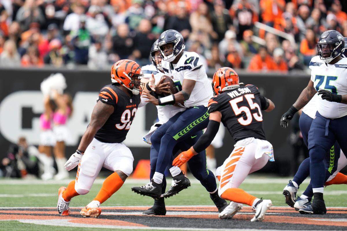 Seattle Seahawks quarterback Geno Smith (7) is sacked by Cincinnati Bengals’ Logan Wilson (55) during the first half of an NFL football game, Sunday, Oct. 15, 2023, in Cincinnati. (AP Photo/Michael Conroy)