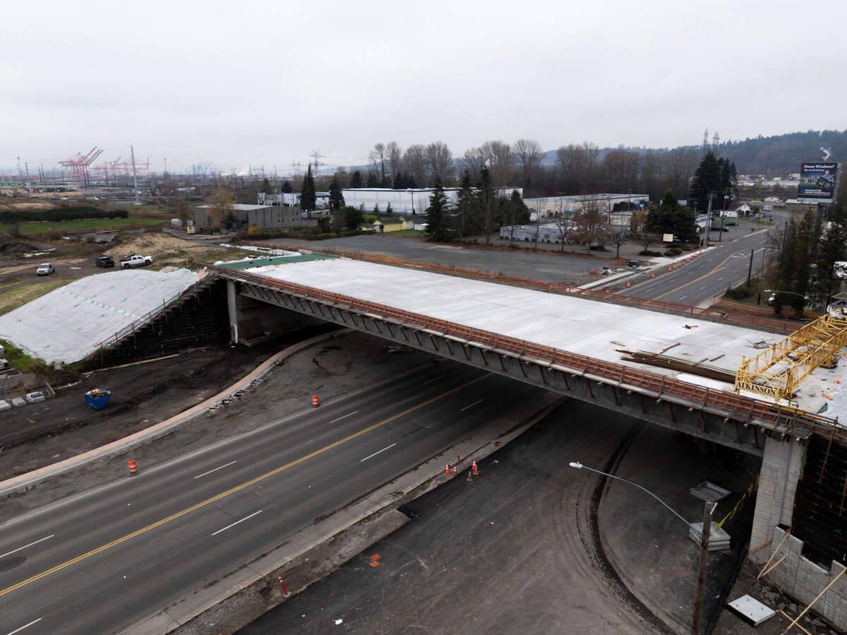 Construction workers make progress on a bridge to connect the new toll road to State Route 509, on Monday, Dec. 2, 2024, in Tacoma.