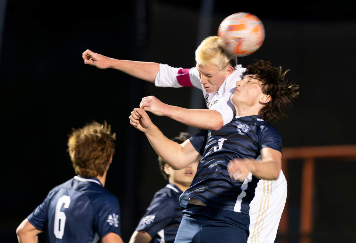 Puyallup midfielder Zack Robertson (22) heads the ball over Bellarmine Prep defender Rory O’Reilly (3) during the match at Bellarmine Preparatory School, on Tuesday, April 16, 2024, in Tacoma, Wash.
