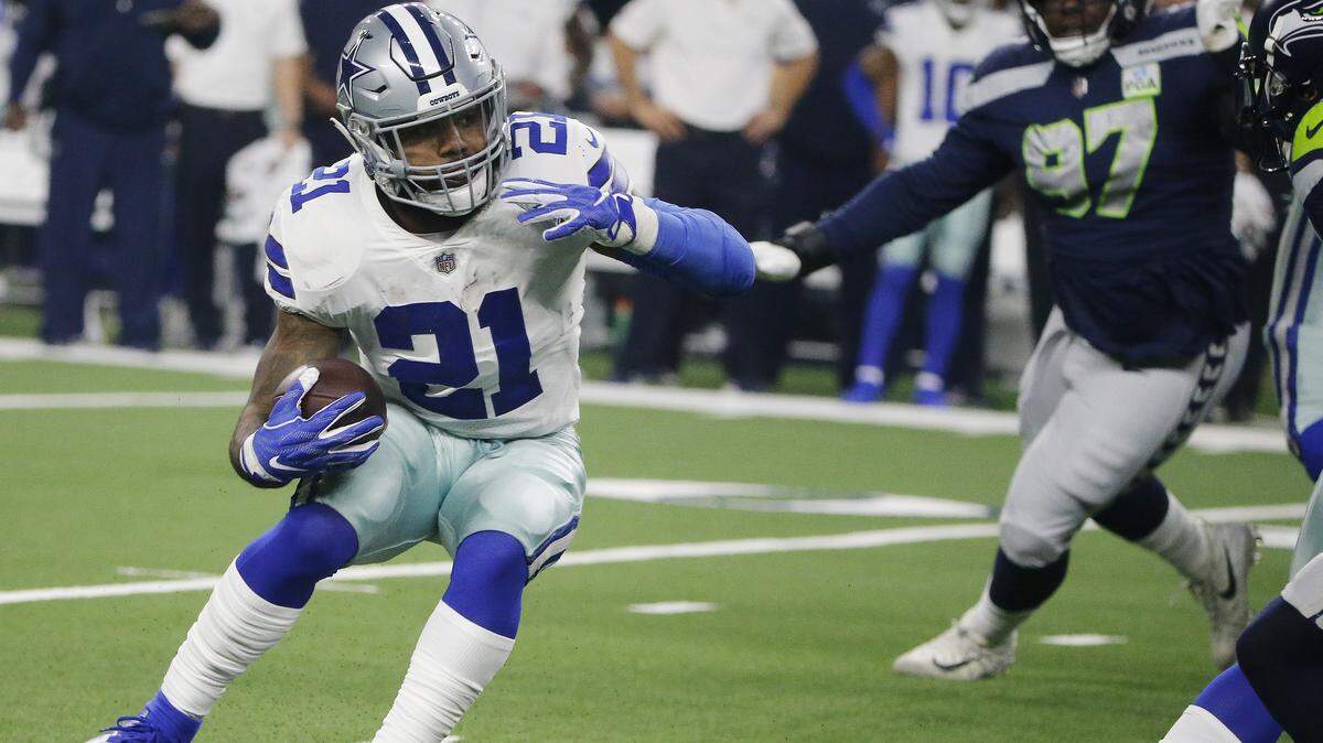 Dallas Cowboys running back Ezekiel Elliott (21) runs against the Seattle Seahawks during the first half of the NFC wild-card NFL football game in Arlington, Texas, Saturday, Jan. 5, 2019. Elliott tested positive for the COVID-19 virus recently.