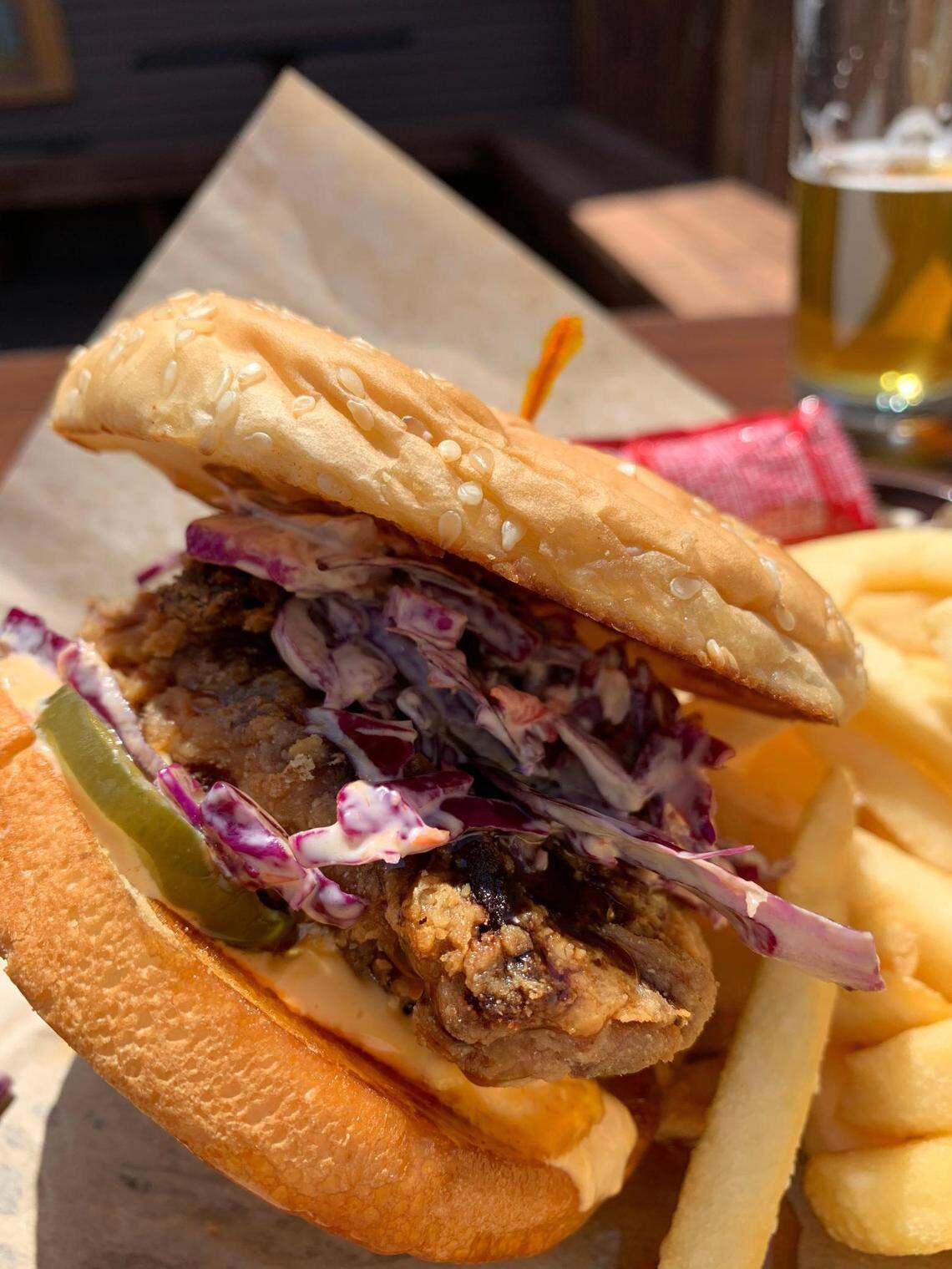 The fried chicken sandwich drizzled with hot honey at Dusty’s Hideaway in Tacoma’s McKinley neighborhood is one of the city’s best things between buns.
