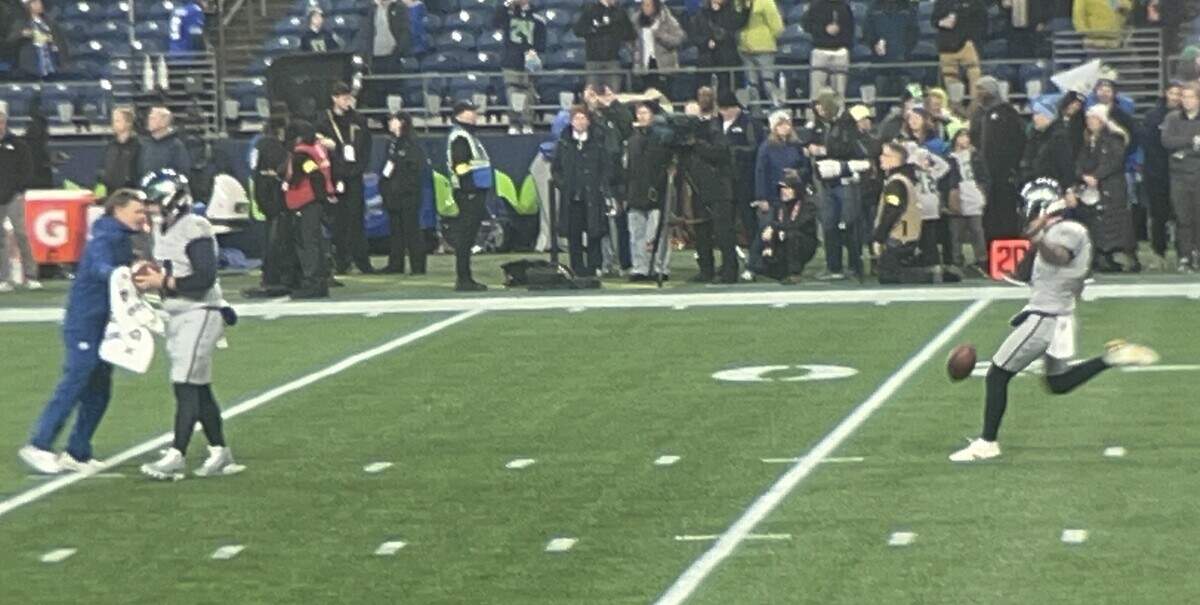 Punter Michael Dickson (right) warms up pregame before the Seahawks played the Los Angeles Rams Thursday, Dec. 18, 2025, at Lumen Field in Seattle. The Seahawks wore new, gray-and-light-green “rivalry uniforms” for the game.