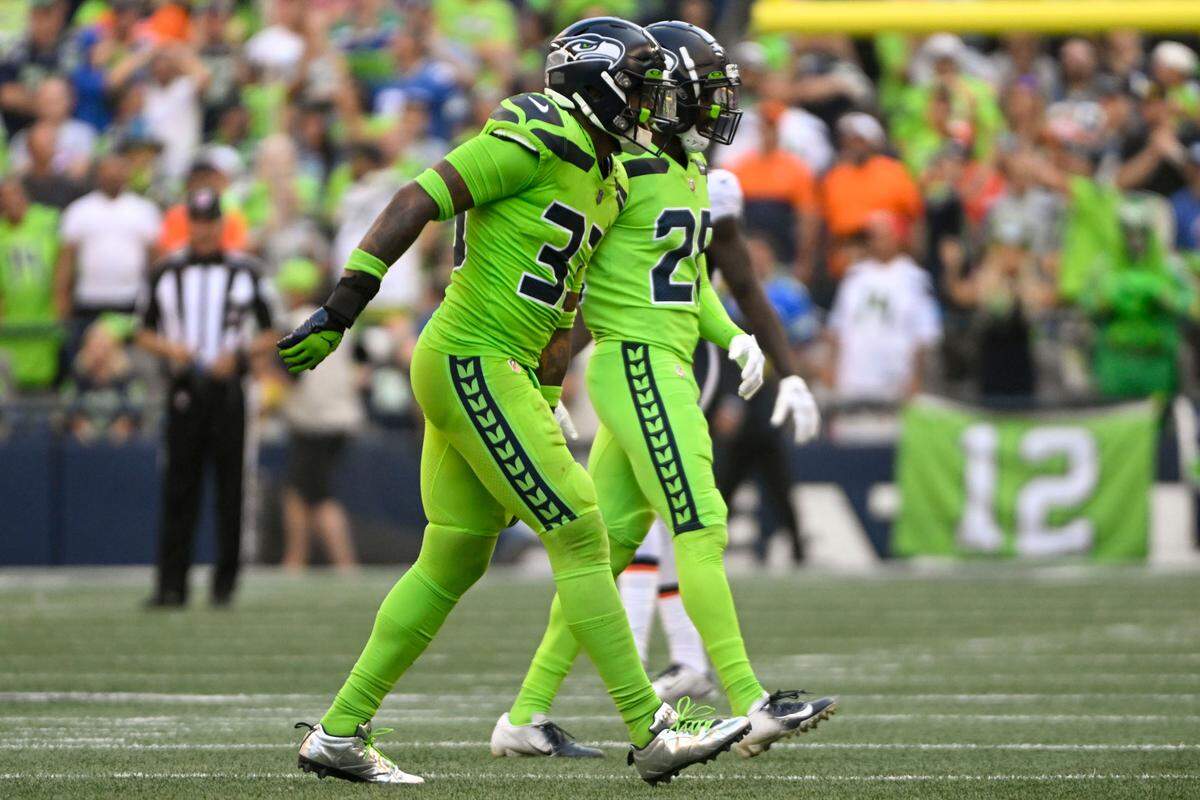 Seattle Seahawks safety Jamal Adams (33) limps off the field after attempting to tackle Denver Broncos quarterback Russell Wilson (3) during the second quarter of an NFL game on Monday, Sept. 12, 2022, at Lumen Field in Seattle.