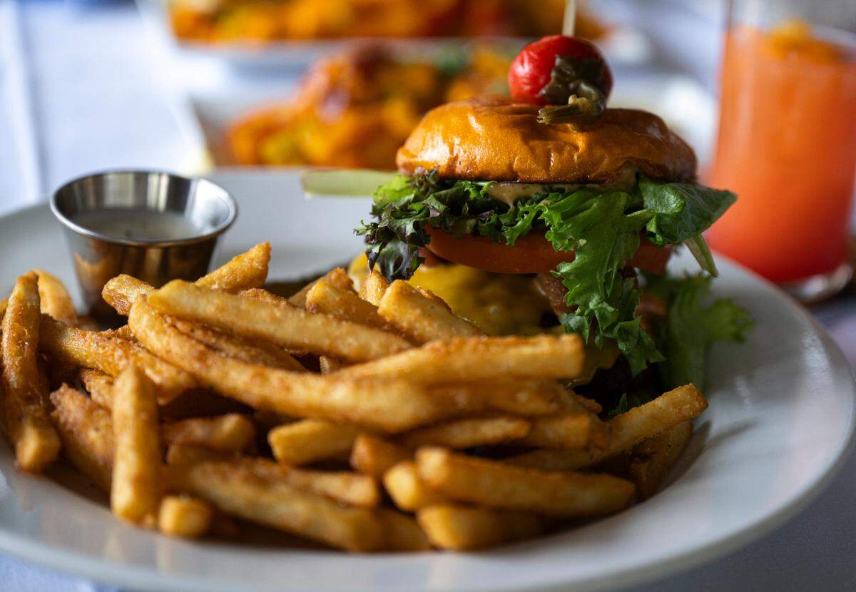 No “grill” is complete without a burger. Johnny’s Burger is served on a sweet-potato bun with pickled onions, lettuce, tomato, house aioli and a pile of beer-battered fries. Pro tip: Ask for the mint chutney to dip.