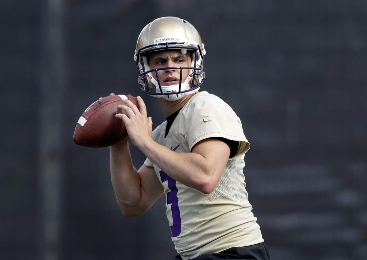 Washington’s quarterback Jake Browning drops back to pass during the NCAA college football team’s practice Friday, Aug. 3, 2018, in Seattle. (AP Photo/Elaine Thompson)