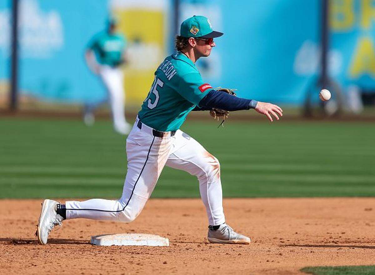 PEORIA, ARIZONA - FEBRUARY 24: Colt Emerson #85 of the Seattle Mariners throws to first base after forcing out a runner at second during the fifth inning of the spring training game against the Chicago White Sox at Peoria Stadium on February 24, 2026 in Peoria, Arizona. (Photo by Mike Christy/Getty Images)