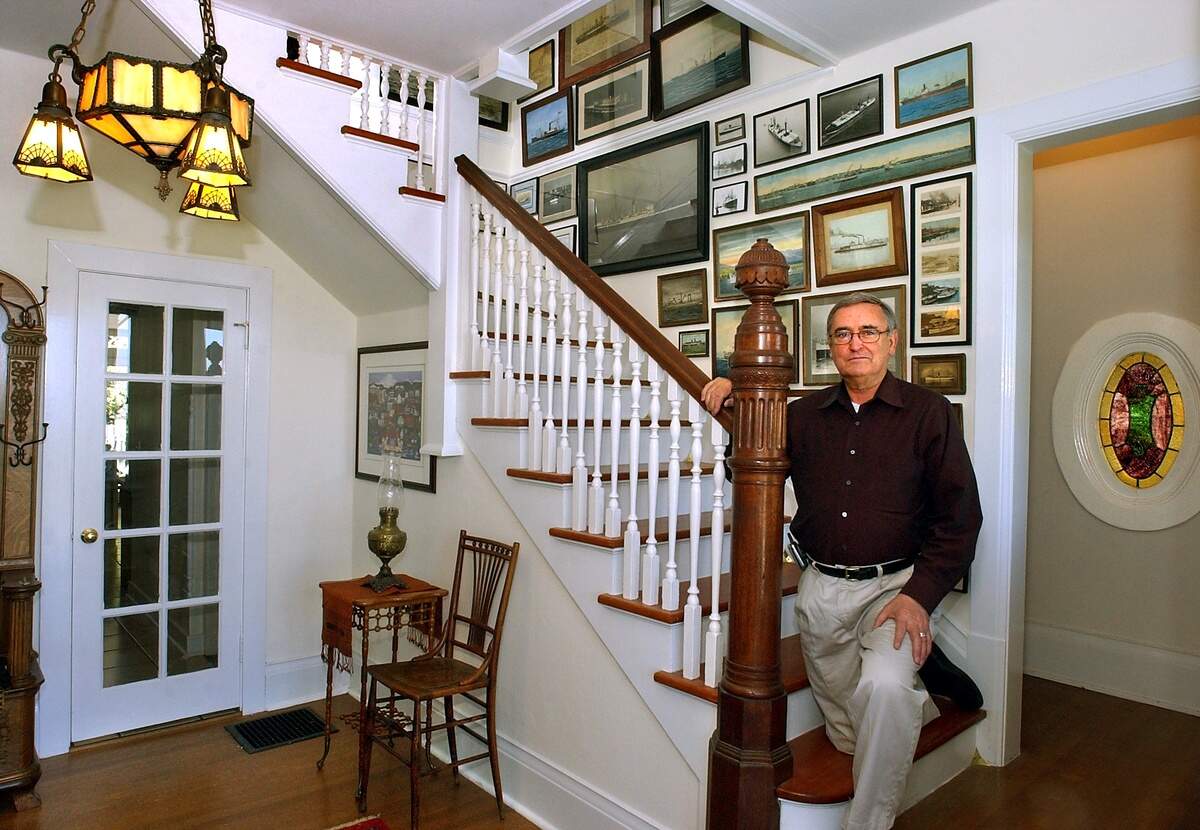 Tacoma merchant and civic leader Bill Evans lined the staircase of his 101-year-old house on North Yakima Avenue with antique photos of ships that have called on Puget Sound. The house where he and wife Ann raised their three children sits on a North End hill with a view of Commencement Bay. Photo taken April 25, 2003.