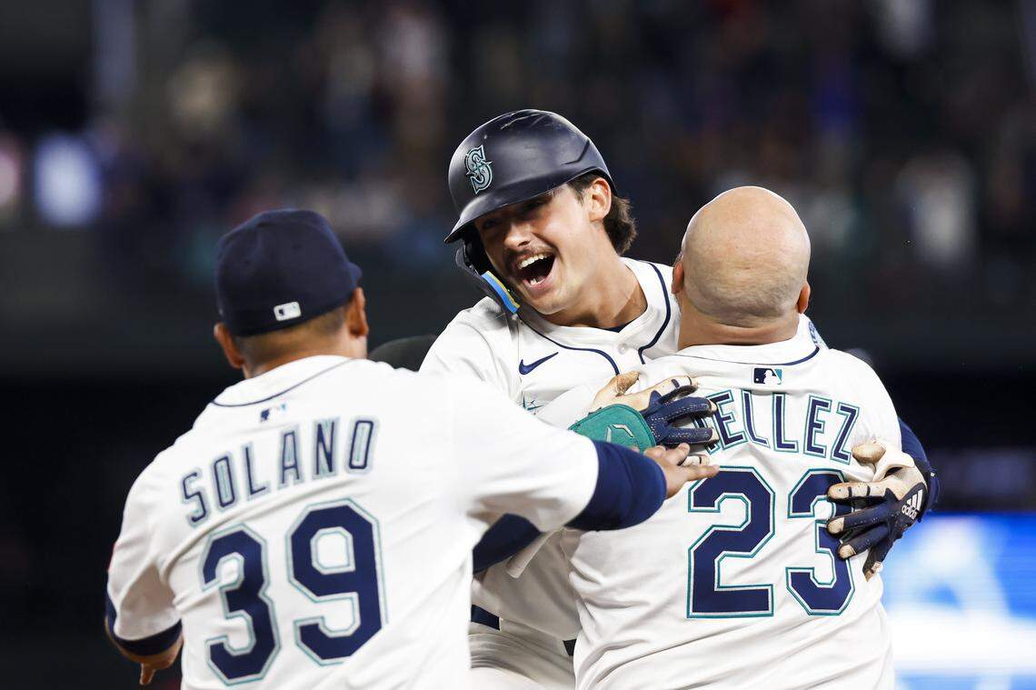 May 31, 2025; Seattle, Washington, USA; Seattle Mariners second baseman Cole Young (2, middle) celebrates with first baseman Rowdy Tellez (23) and infielder Donovan Solano (39) following a walk-off RBI-fielders choice against the Minnesota Twins during the eleventh inning at T-Mobile Park. Mandatory Credit: Joe Nicholson-Imagn Images
