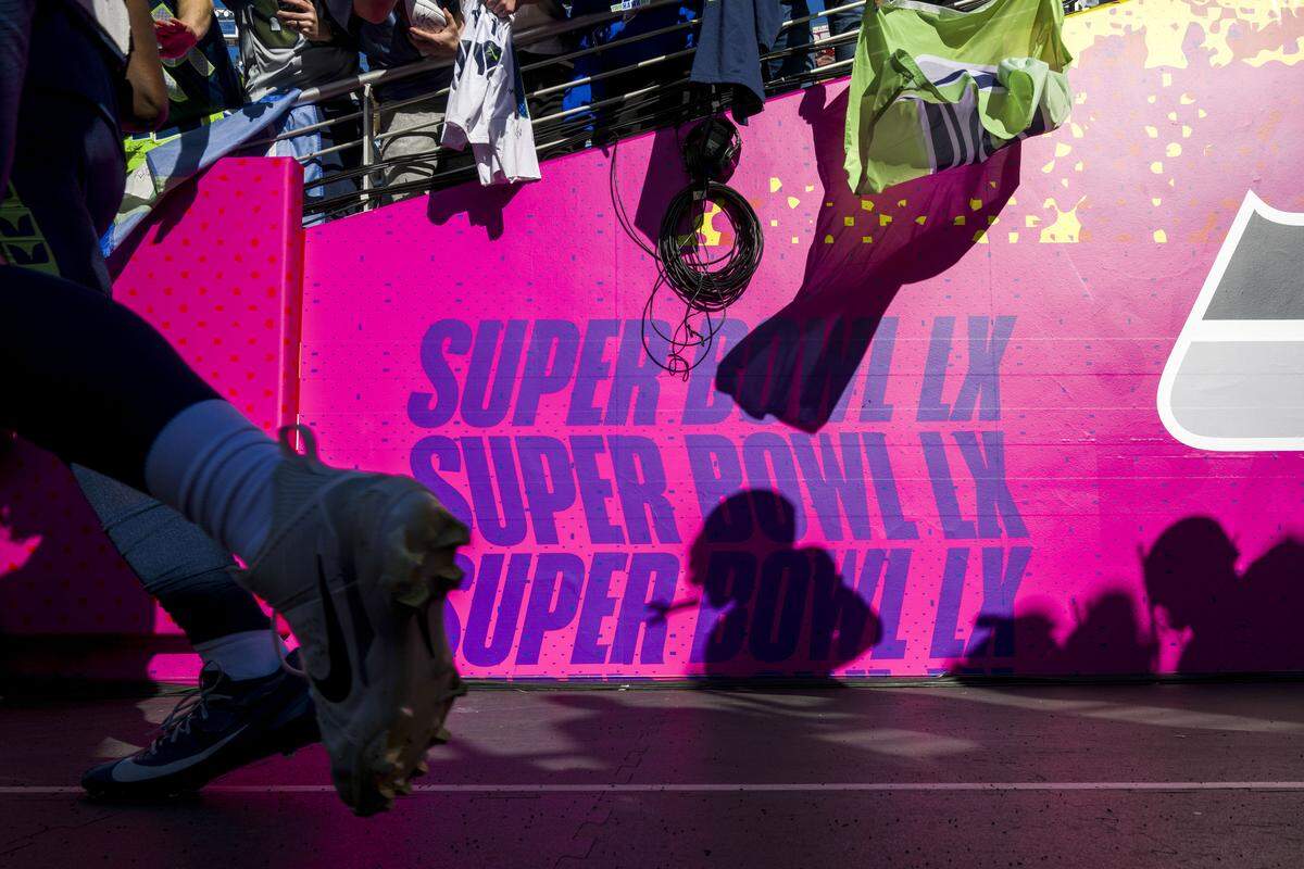 Fans look for a quick autograph as Seahawk players run on to the field for warm ups prior to the start of Super Bowl LX at Levi's Stadium on Feb. 8, 2026 in Santa Clara, Calif.