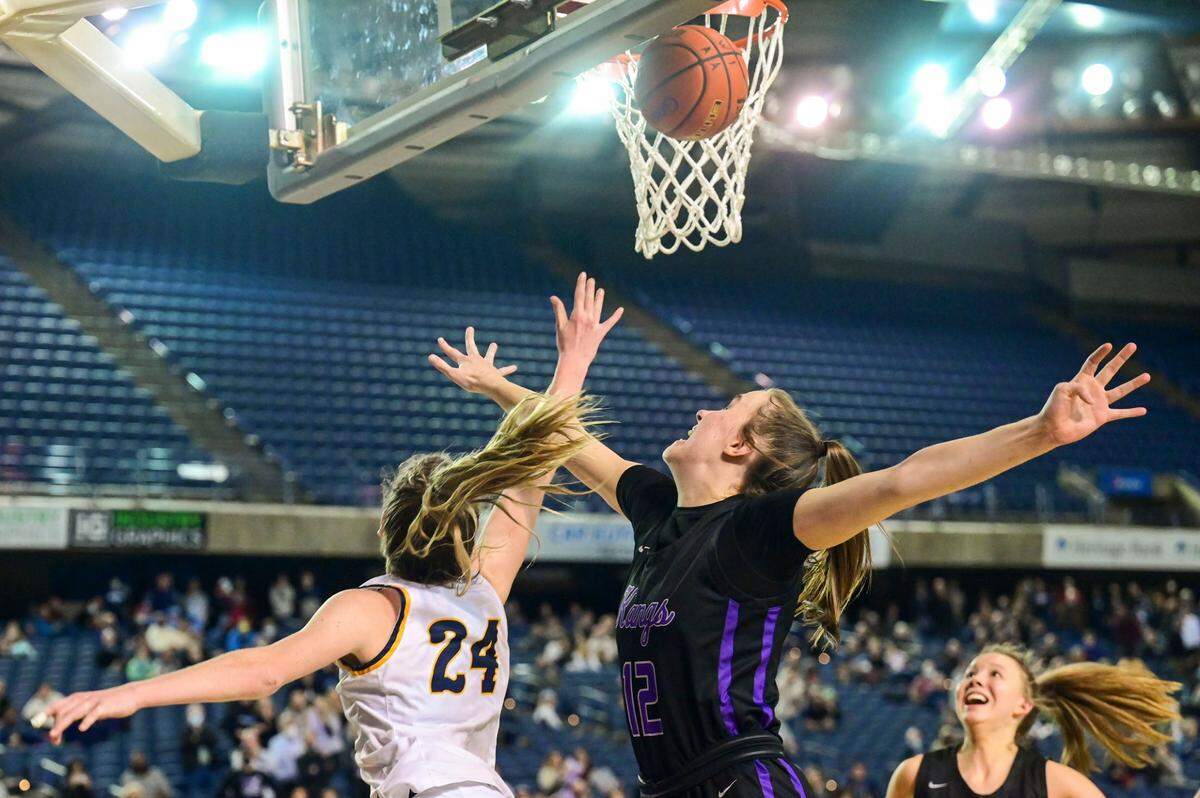 Mead guard Teryn Gardner (24) attempts a shot in the final seconds of the fourth quarter as Lake Washington forward Elise Hani (12) defends during a Class 3A semifinal state tournament game on Friday, March 4, 2022, at the Tacoma Dome, in Tacoma, Wash.