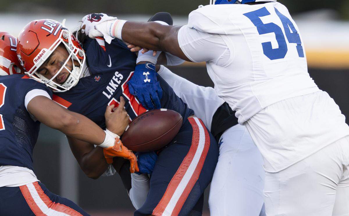 Lakes quarterback Jadis Lefono (10) fumbles the ball under pressure from Curtis defensive lineman Jereme Scott Jr. (54) during the first half of the game at Harry Lang Stadium, on Friday, Sept. 19, 2025, in Lakewood, Wash.