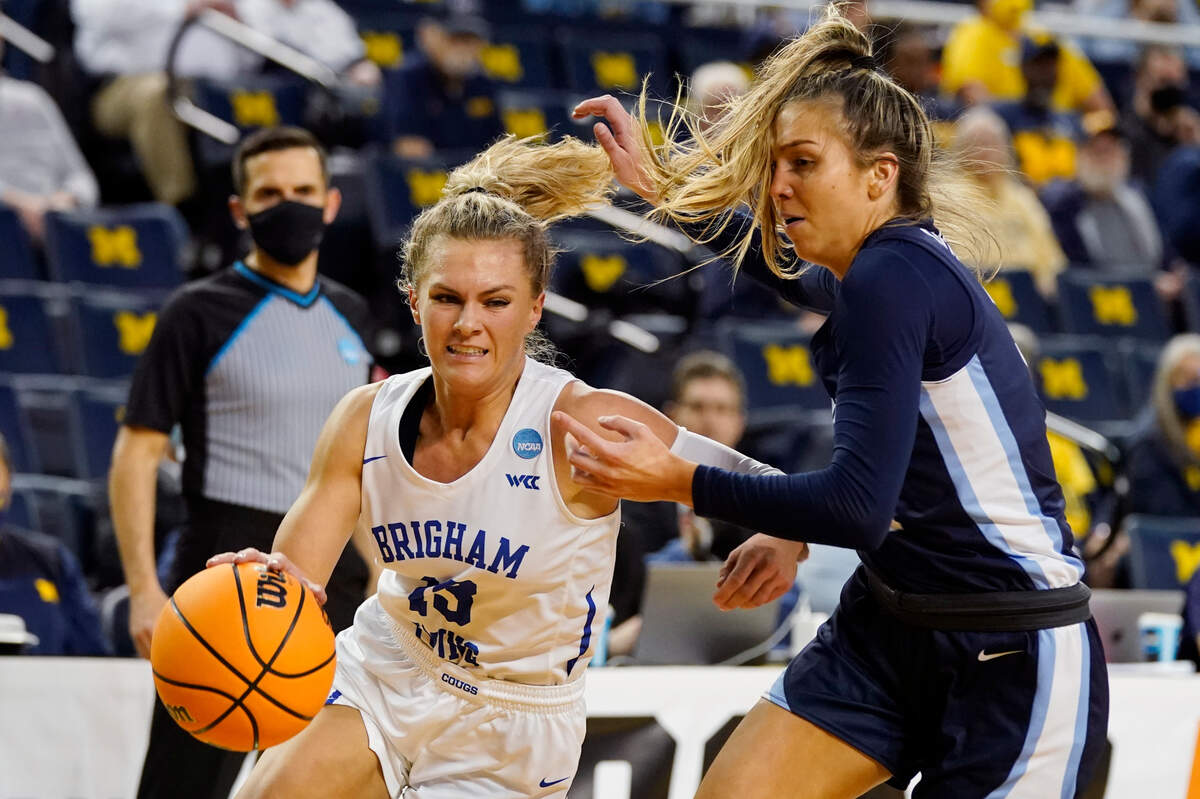 BYU guard Paisley Harding (13) drives as Villanova guard Bella Runyan, right, defends during the second half of a college basketball game in the first round of the NCAA tournament, Saturday, March 19, 2022, in Ann Arbor, Mich. (AP Photo/Carlos Osorio)