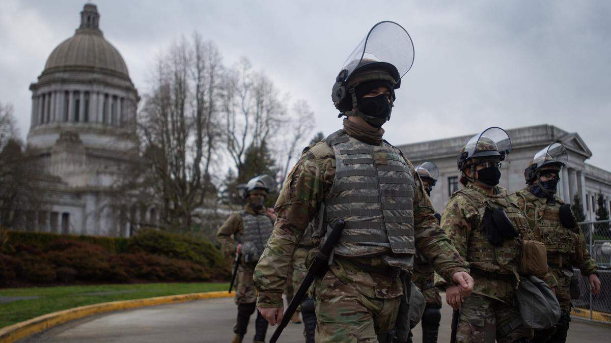 The Washington National Guard and Washington State Patrol operate a perimeter around the Washington Capitol Campus in Olympia on Jan. 17, 2021. About 700 members of the Guard recently deployed to Poland.