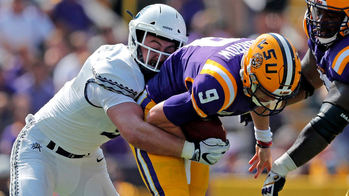 LSU quarterback Joe Burrow (9) is sacked by Utah State linebacker David Woodward in the first half of a game in October. Woodward, an Olympia High School grad,is forgoing his final year of eligibility at Utah State and has declared for the NFL Draft.