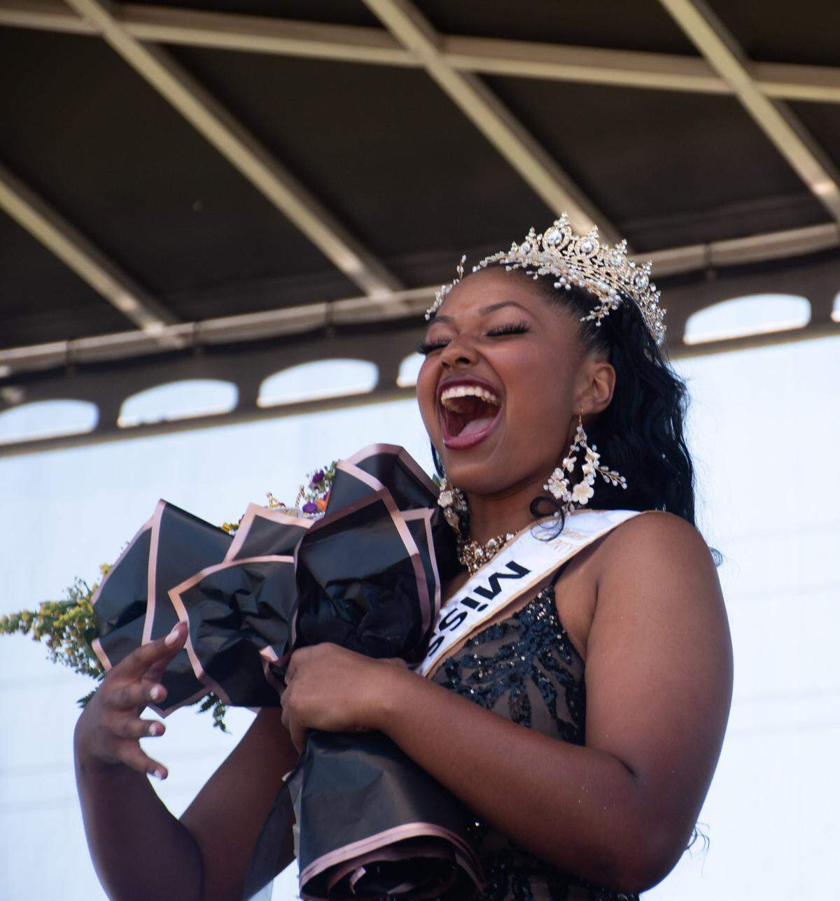 Destiny Bass, of Pierce County, lets out a joyful scream after being crowned the 2024 Miss Juneteenth during the Juneteenth Celebration held in Stewart Heights Park on Wednesday, June 19, 2024, in Tacoma.