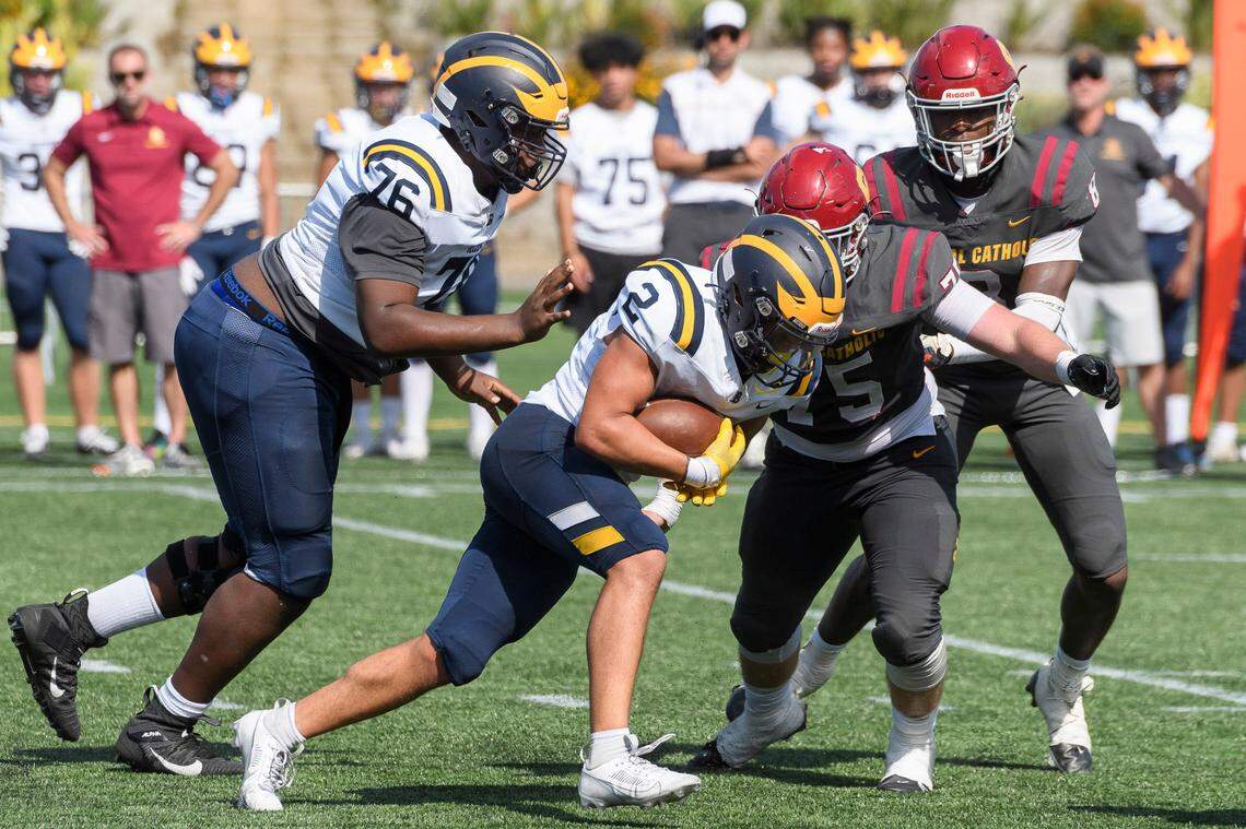 Bellevue High School’s Demetri Manning (76) and Ryken Moon (2).