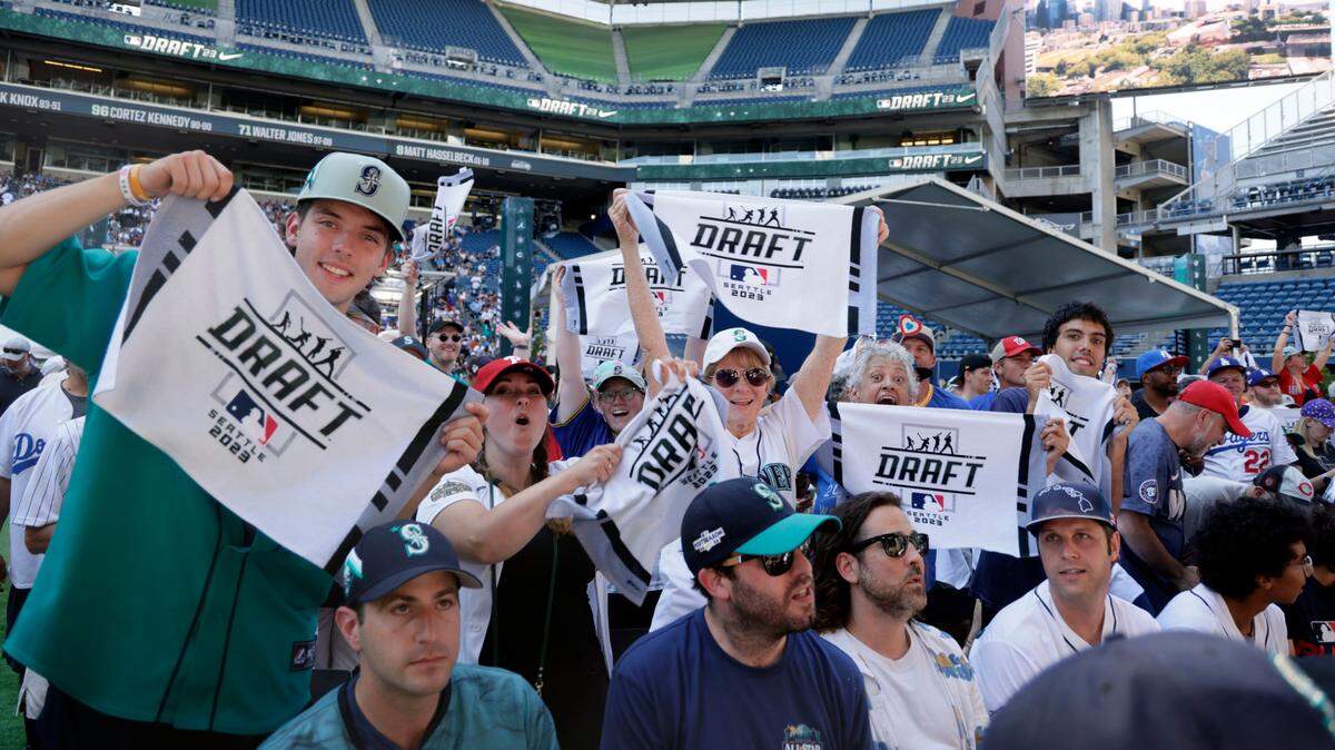 Fans prepare for baseball’s amateur draft Sunday, July 9, 2023, in Seattle. (AP Photo/John Froschauer)