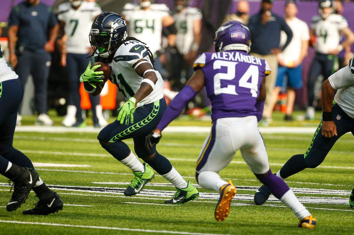 Seattle Seahawks running back Alex Collins (41) cuts aways from Minnesota Vikings cornerback Mackensie Alexander (24) in the first half of an NFL football game in Minneapolis, Sunday, Sept. 26, 2021. (AP Photo/Bruce Kluckhohn)