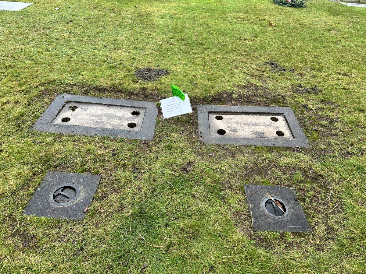 A photo taken on Dec. 4, 2025 of two veteran plaques that have been damaged at Sumner Cemetery at 12324 Valley Ave East. Normally, these graves would have plates with a person’s name and dates on them. The Sumner Police Department is investigating the incident, which impacted 15 plaques at the cemetery. They believe the incident happened on Saturday, Nov. 29.