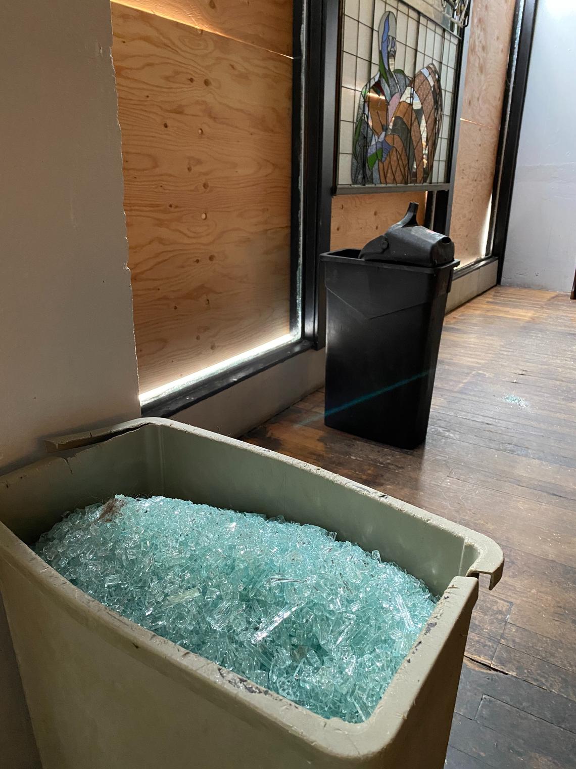 A garbage container is filled with glass after three picture windows and a stained glass window were broken late Monday night at Harmon Brewing Co. on Pacific Avenue in Tacoma.