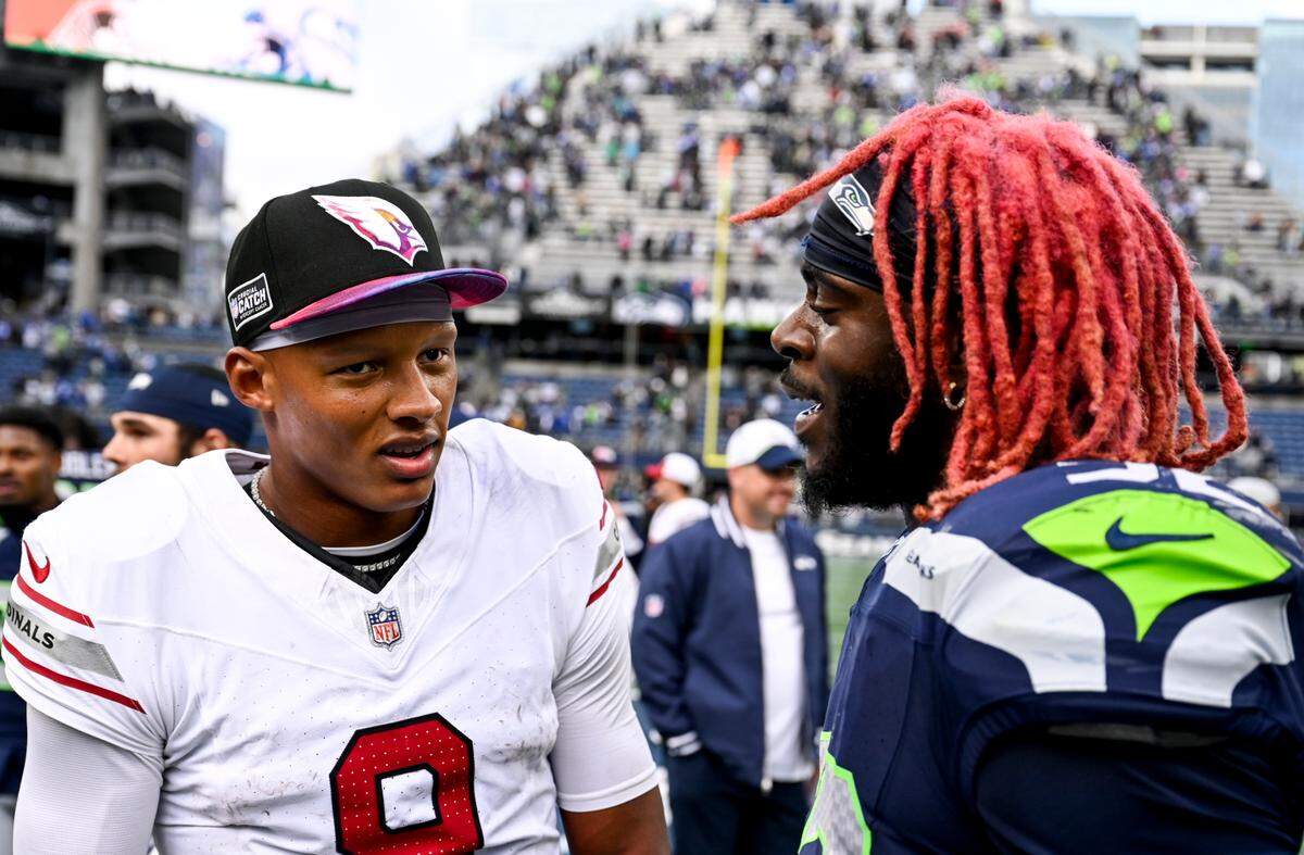 Arizona Cardinals quarterback Joshua Dobbs (9) and Seattle Seahawks linebacker Darrell Taylor (52) talks after the Seahawks’ 20-10 victory at Lumen Field, Sunday, Oct. 22, 2023, in Seattle, Wash.