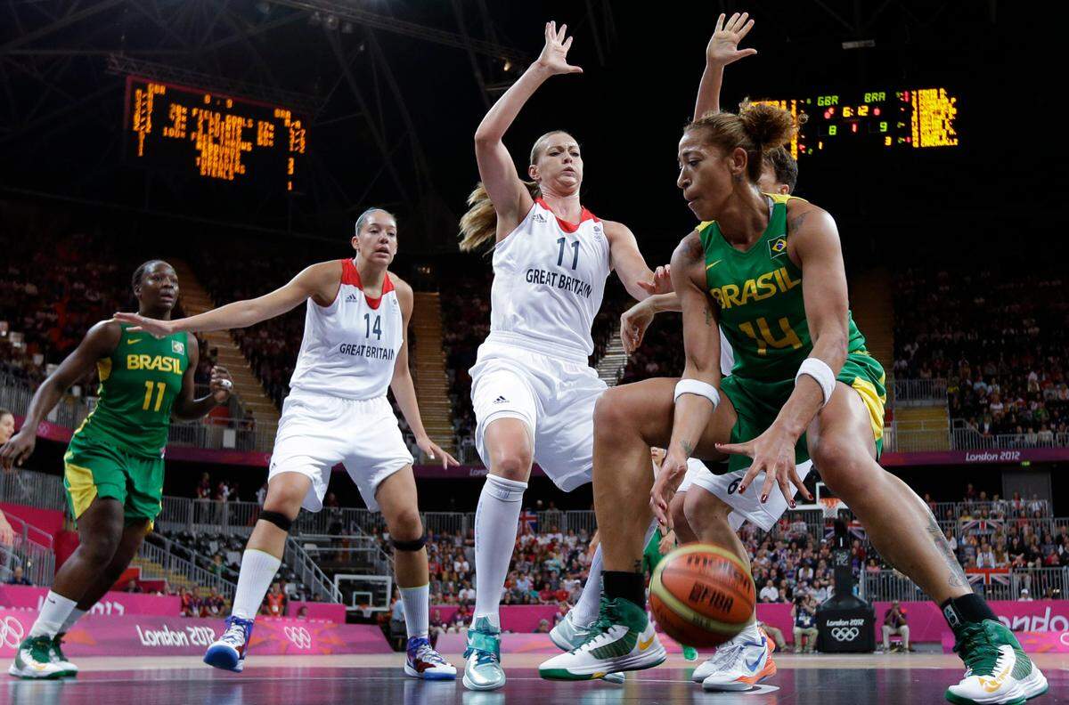 Brazil’s Erika Souza, right, is defended by Great Britain’s Kim Butler (11) and Great Britain’s Azania Stewart (14) during a preliminary women’s basketball game at the 2012 Summer Olympics, Sunday, Aug. 5, 2012, in London. (AP Photo/Eric Gay)