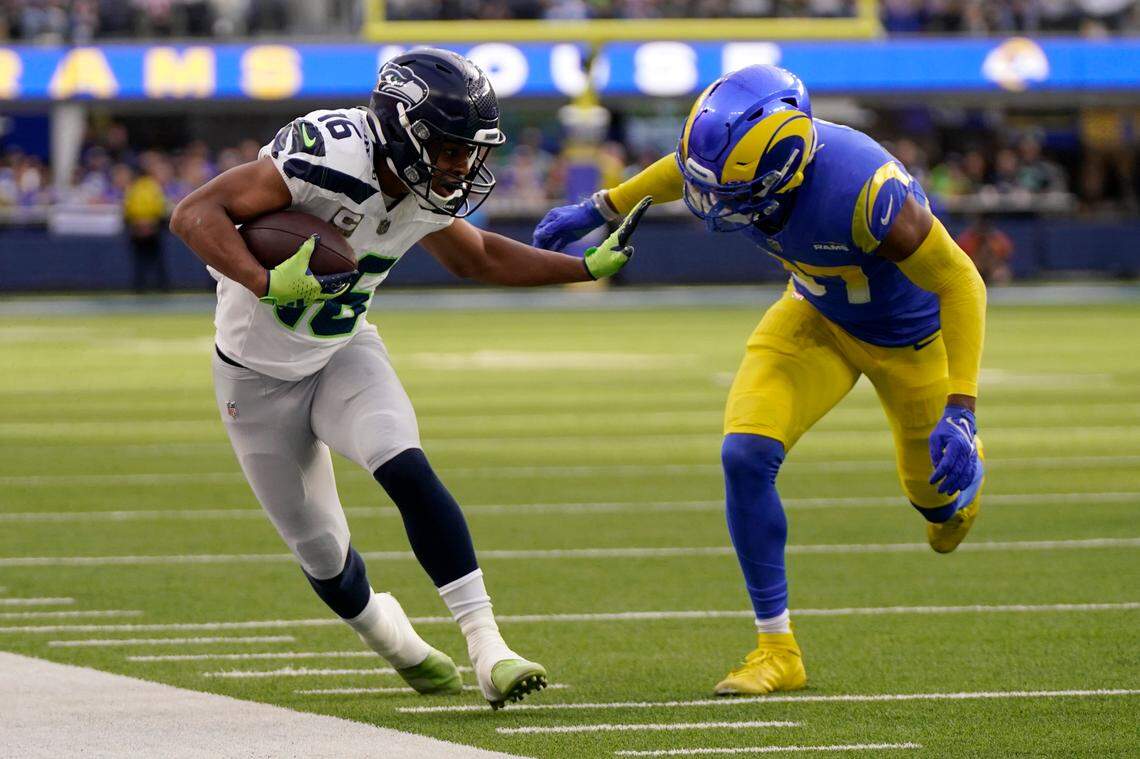 Seattle Seahawks wide receiver Tyler Lockett (16) fends off Los Angeles Rams safety Quentin Lake (37) during the first half of an NFL football game Sunday, Nov. 19, 2023, in Inglewood, Calif. (AP Photo/Mark J. Terrill)