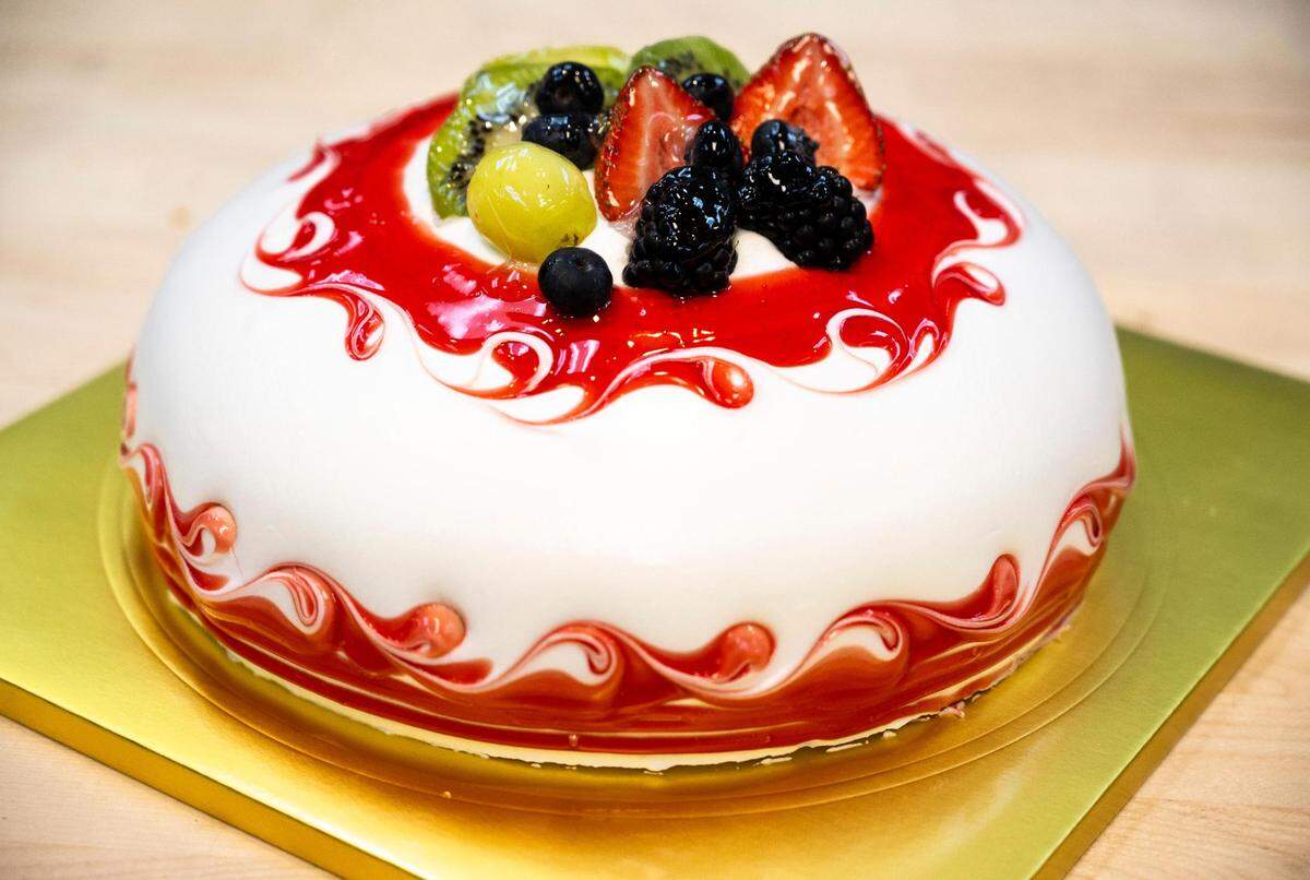 Chef Chris Chung creates intricate designs on his layered cakes, domed with fresh cream icing.