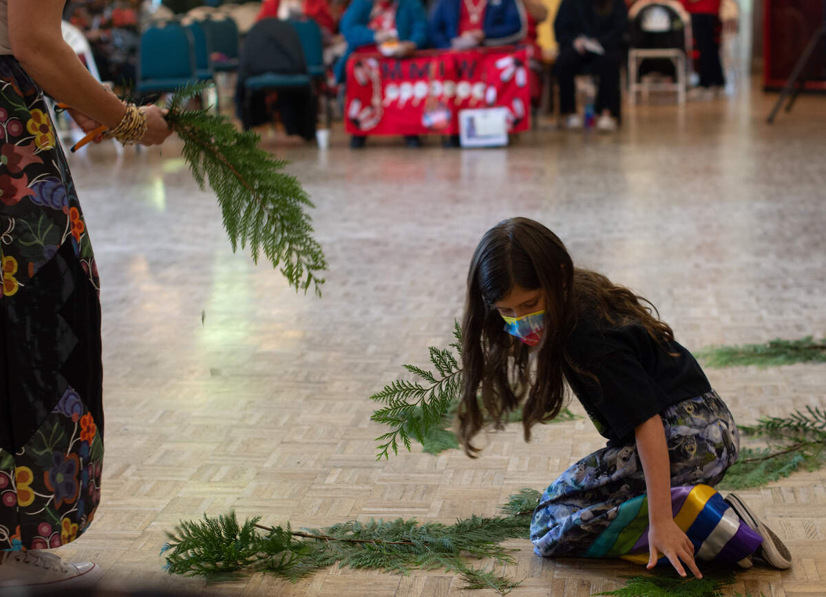 Vida Hurta, right, and her mother Jennifer Vickers of the Nipmuc Nation place a circle of cedar in the center of the stage at the National Day for Awareness and Healing for Missing and Murdered Indigenous Women, People and Families Saturday, May 7, at Daybreak Star Indian Cultural Center in Seattle.