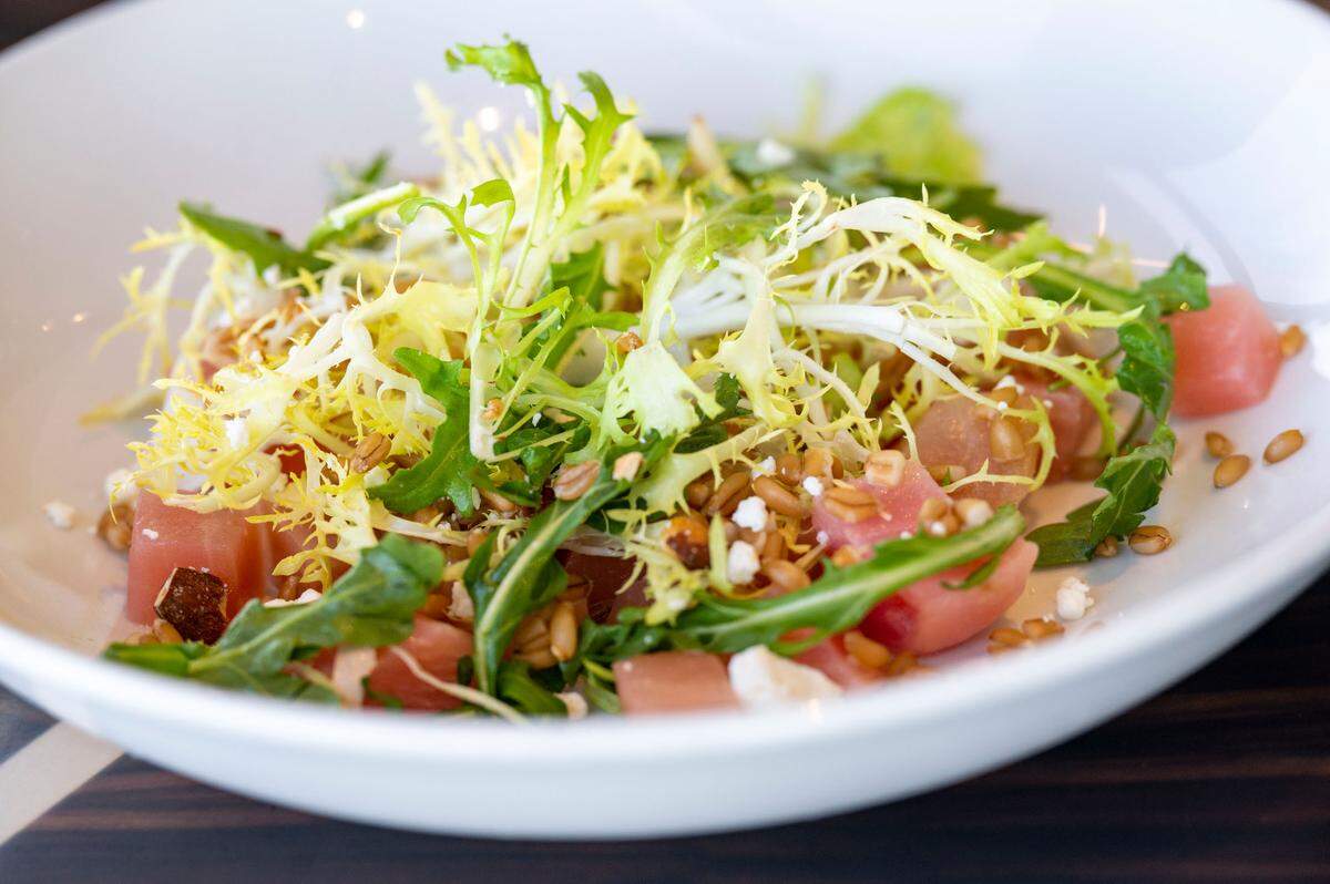 Available at lunch and dinner, the beet salad combines a Chioggia beet with goat cheese, frisee and almonds, lightly tossed in a sherry vinaigrette.