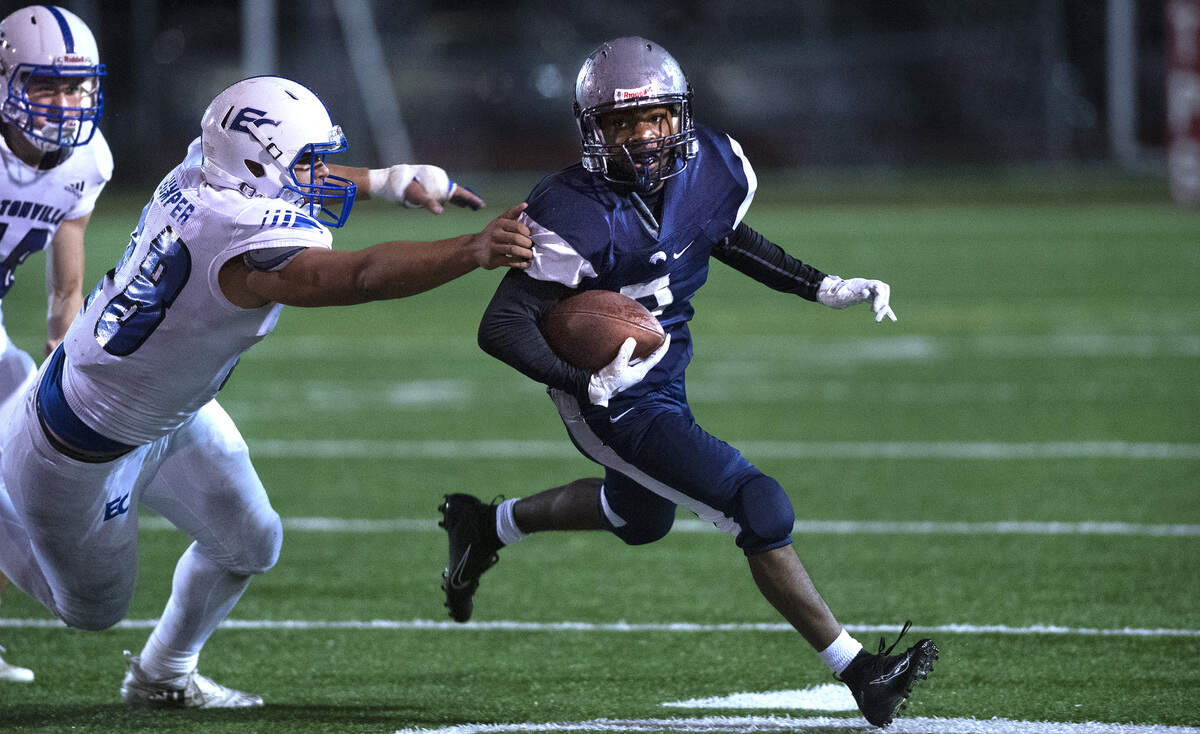 River Ridge running back Darion Brown tries to turn the corner on Eatonville linebacker Caden Jumper during Friday night’s football game at South Sound Stadium in Lacey on Oct. 4, 2019.