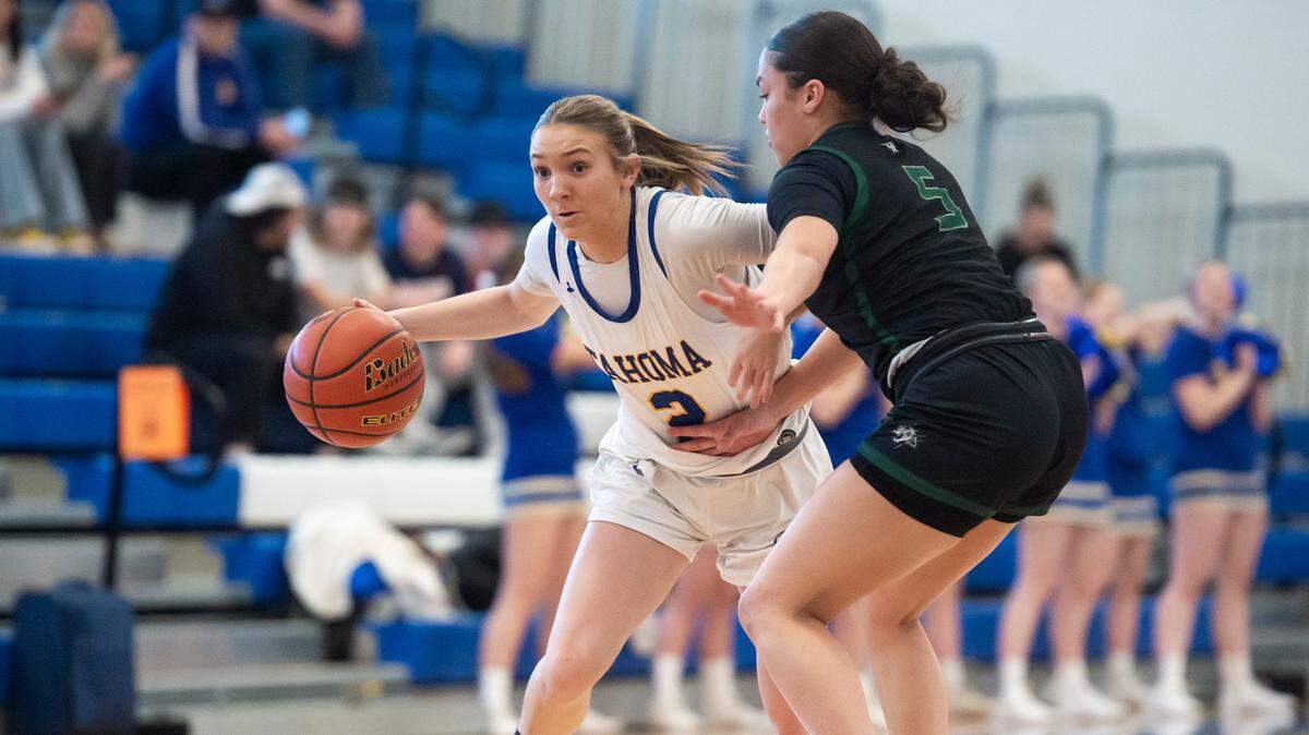 Tahoma guard Hope Hassmann (2) drives down the court past Emerald Ridge guard Monique Carter (5) in the first quarter of a 4A district semifinal game at Curtis High School in University Place, Wash. on Feb. 15, 2023. Tahoma defeated Emerald Ridge 50-45.