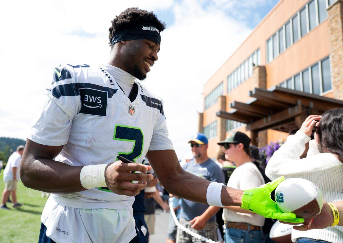 Seattle Seahawks safety Nick Emmanwori (3) signs autographs after training camp at Virginia Mason Athletic Center on Friday, July 25, 2025, in Renton, Wash.