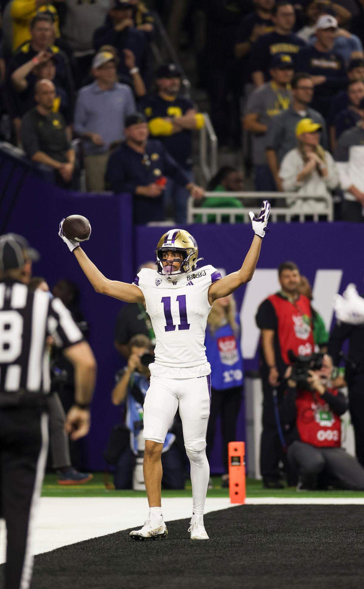 Washington Huskies wide receiver Jalen McMillan (11) celebrates his touchdown during the second quarter of the College Football Playoff National Championship game against the Michigan Wolverines at NRG Stadium on Monday, Jan. 8, 2024, in Houston.