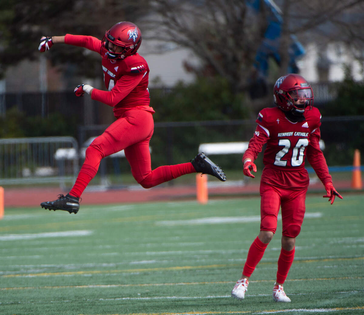 Kennedy Catholic defensive back Kieran Collins leaps for joy after the Lancers defense forced a first-half turnover in a 4A NSPL matchup at Highline Stadium in Burien, Wash., on Saturday, March 27, 2021.