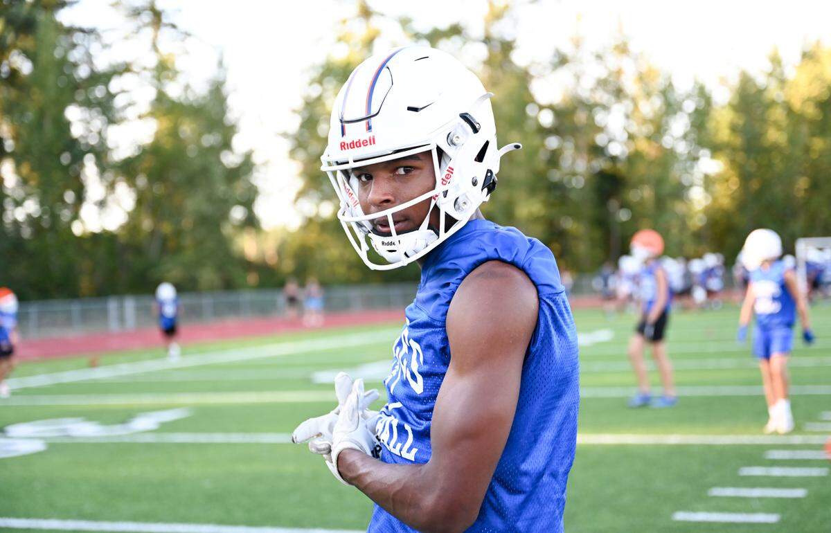 Graham-Kapowsin wide receiver Malachi Durant demonstrates a catch during a football practice at Graham-Kapowsin High School, Wednesday, Aug. 16, 2023, in Graham, Wash.