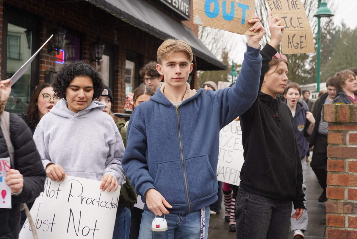 Gig Harbor High School students walked to the corner of Pioneer Way and Harborview Drive in Gig Harbor, Wash., during a walkout protesting recent acts by federal immigration enforcement, Friday, Feb. 13, 2026.