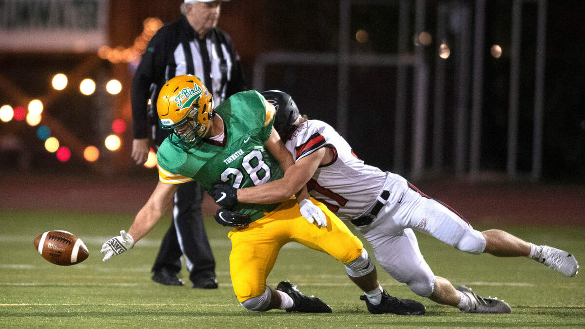 Camas linebacker Jon Schultz forces a fumble from Tumwater running back Ryan Orr during Friday night’s high school football game against the Camas Papermakers at Tumwater District Stadium in Tumwater, Washington, on Oct. 15, 2021. Camas’ defensive back Mark Thorkelson recovered the fumble.